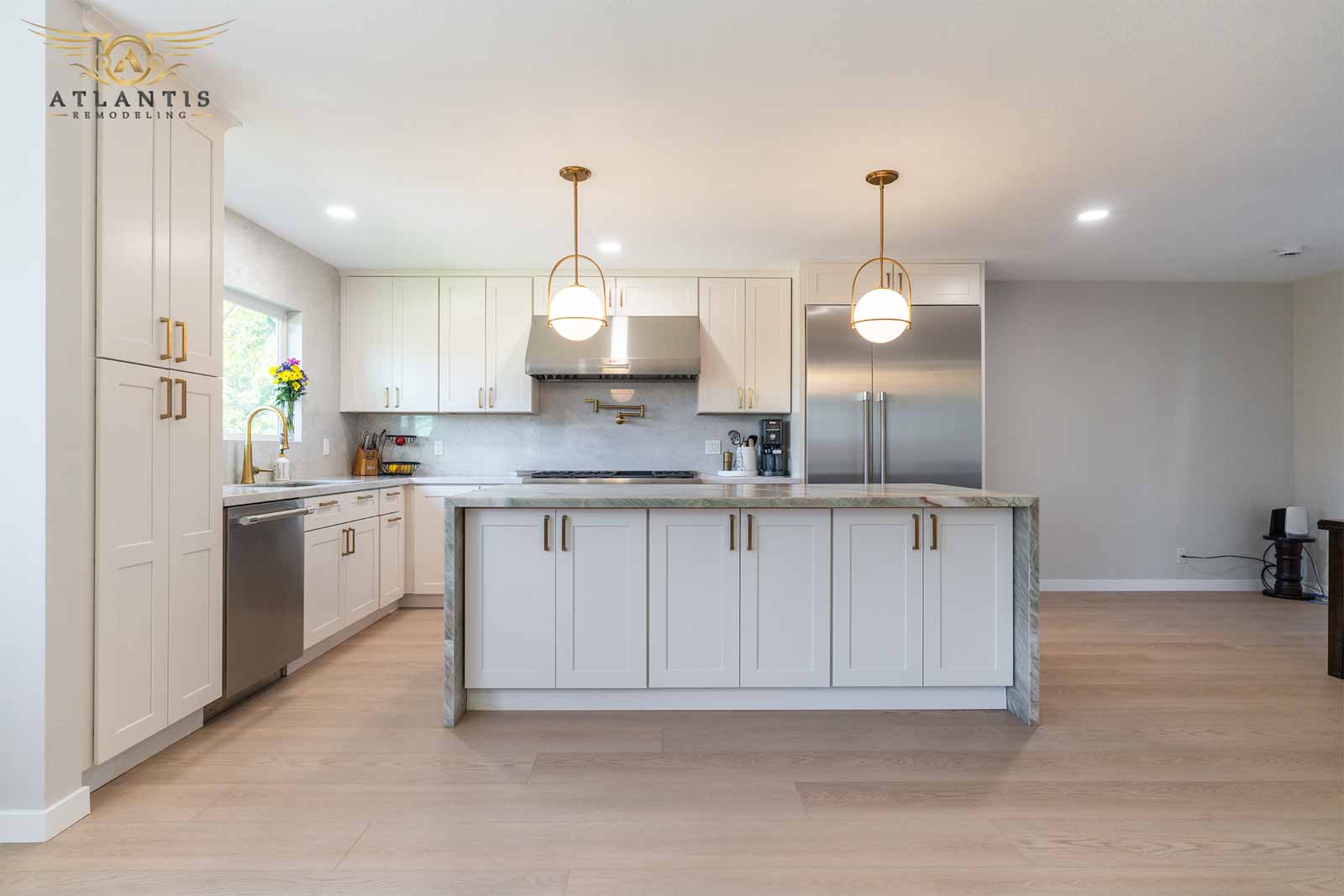 Premium kitchen remodel featuring marble waterfall island and gold fixtures
