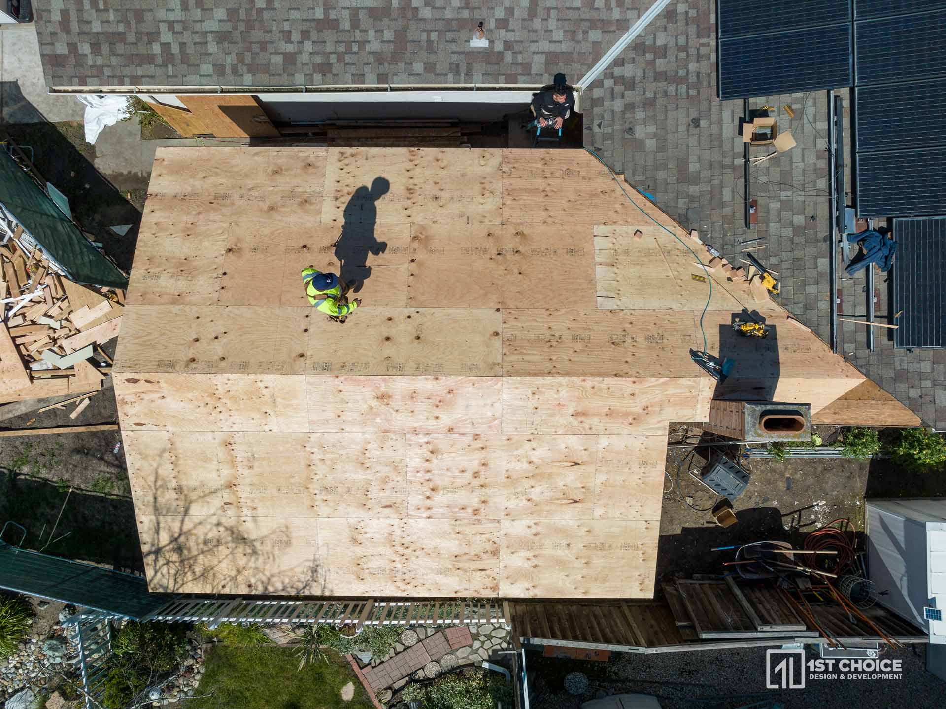 Complete exterior transformation with modern paint, black-framed windows, and solar panels