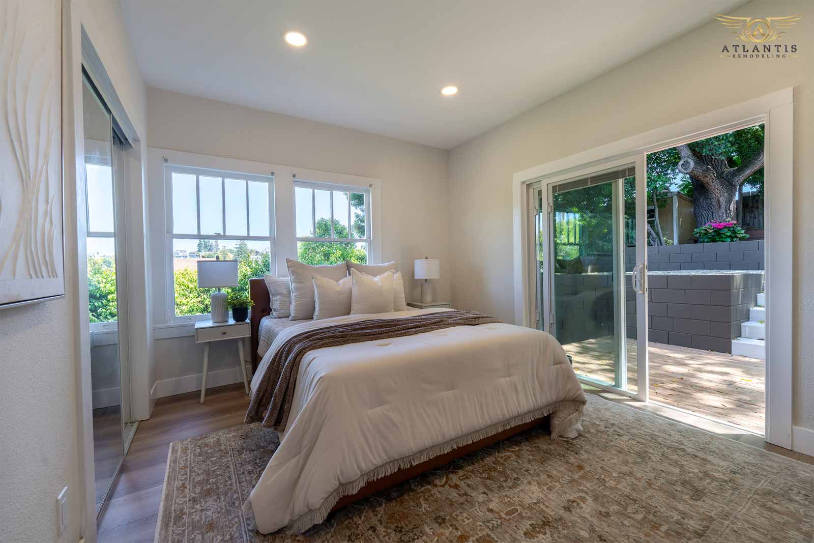 Bright master bedroom with sliding glass patio doors and natural light