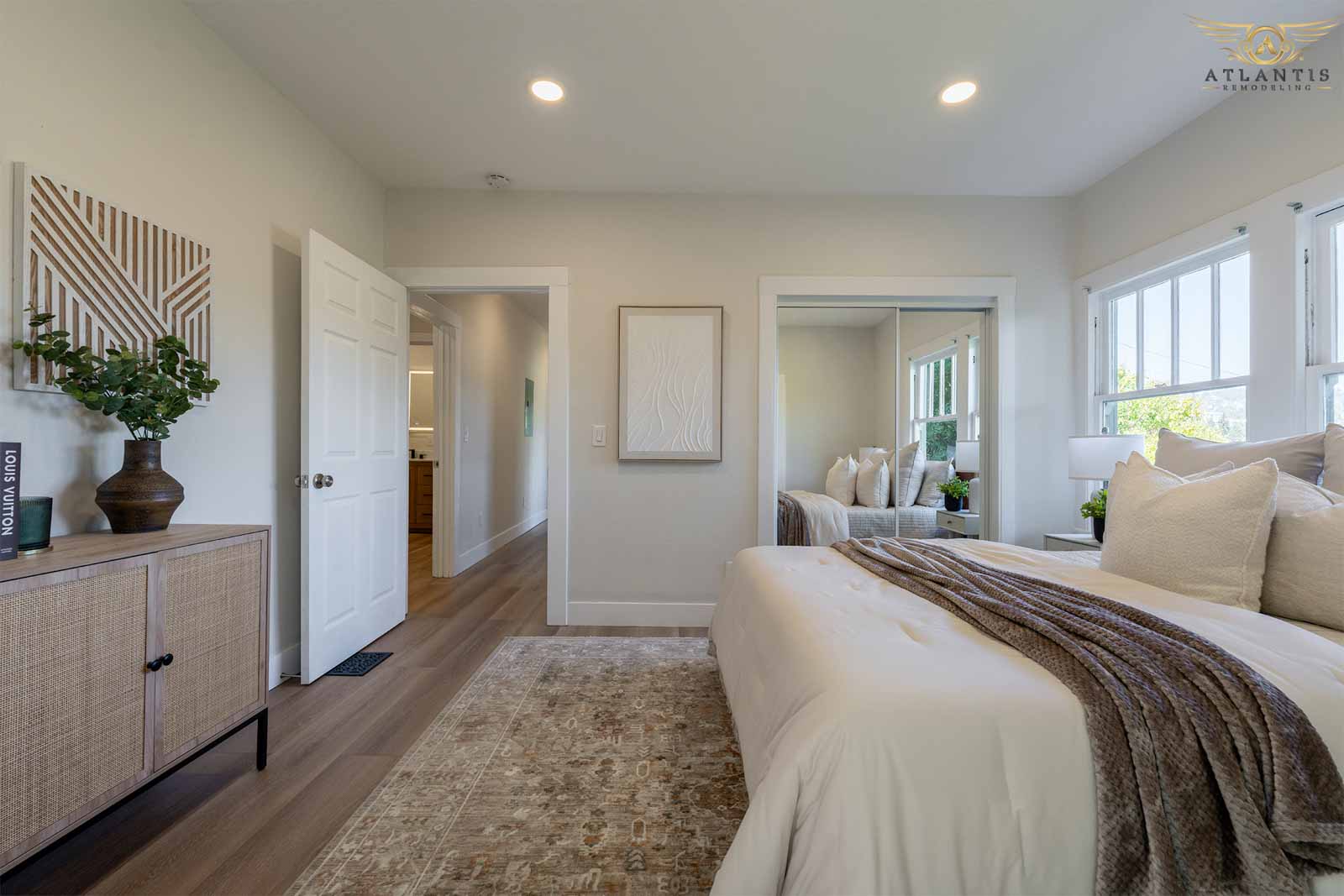 Spacious master bedroom with rattan console and mirrored closet