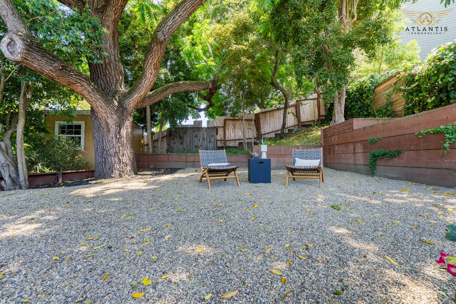 Gravel patio with fire pit and lounge chairs