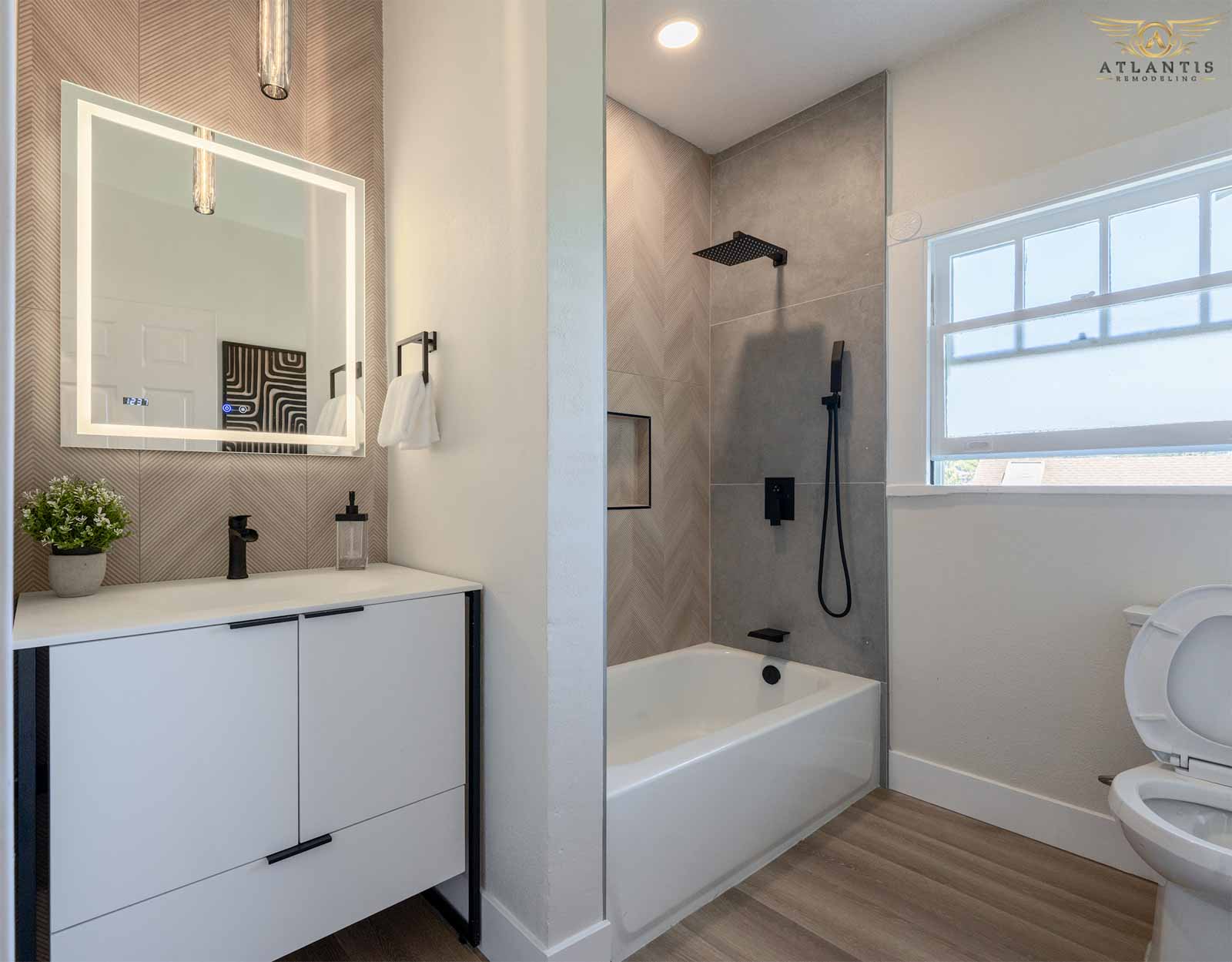 Updated bathroom with white vanity and herringbone tile