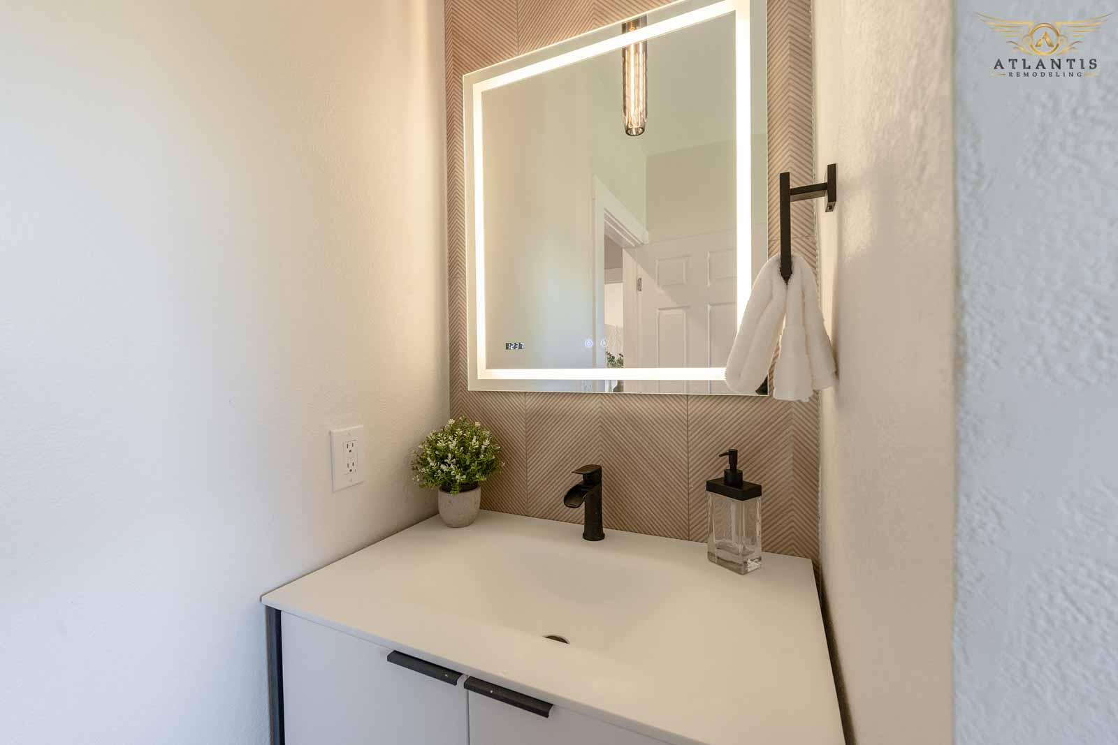 Elegant powder room with LED backlit mirror